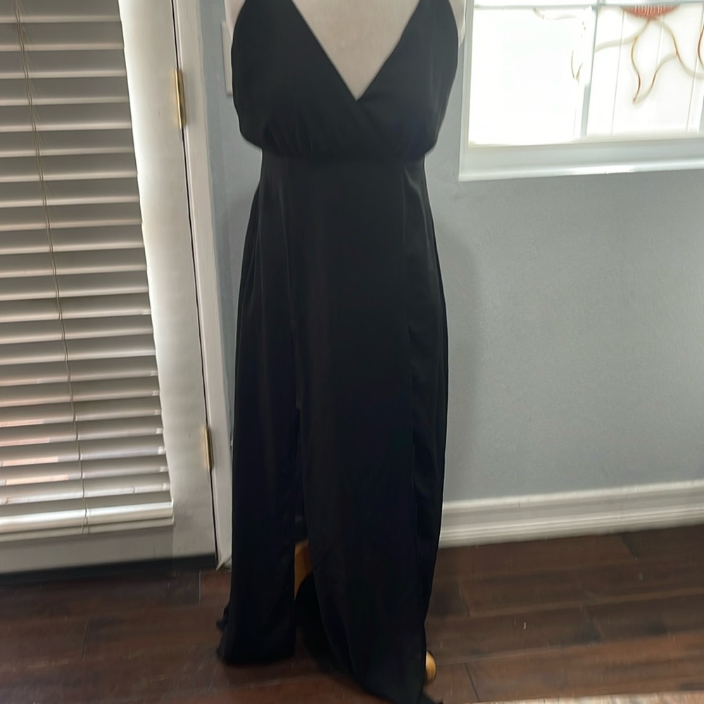 Black maxi dress. Spaghetti straps and two spots in the front.